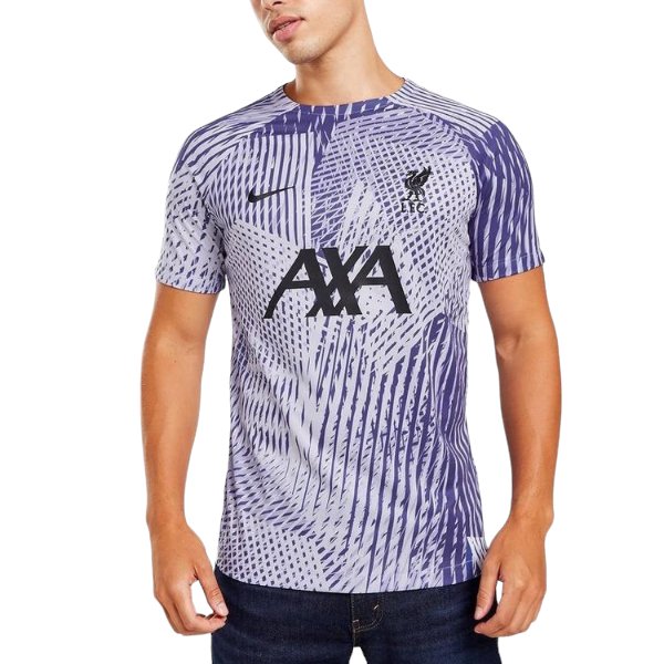 Man wearing a purple, geometric-patterned soccer jersey with the AXA sponsor logo on the chest.