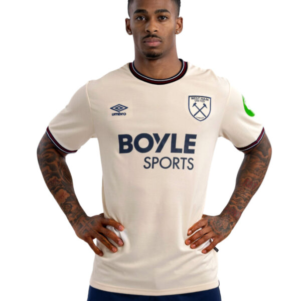 Male athlete standing with hands on hips, wearing a cream West Ham United rugby/football jersey with Boyle Sports sponsor logo.