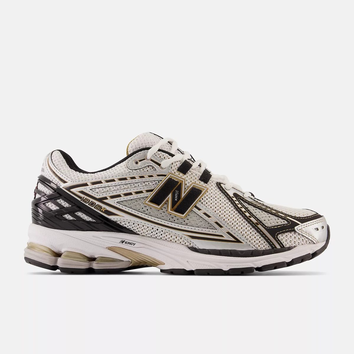 White running shoe with black and gold accents shown from the side, mesh upper and chunky sole visible.