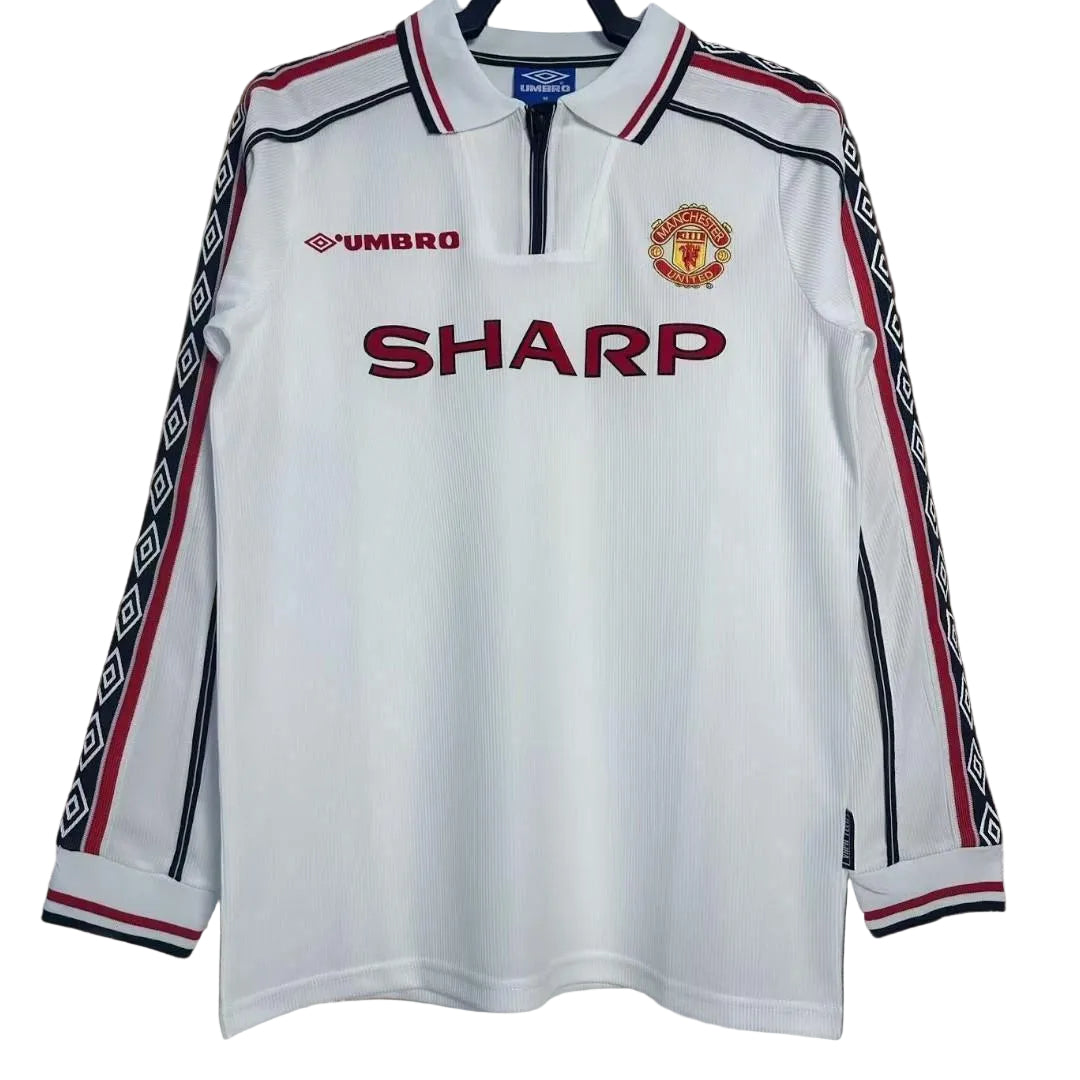 m79941570435_1 | UAE SPORT STORE Manchester United white away jersey with SHARP sponsorship, Umbro logo, and club crest on the chest; red and black striping on sleeves