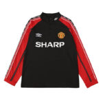 Manchester United training jacket: black body, red sleeves with white stripes, team crest on chest and SHARP sponsor text front center.