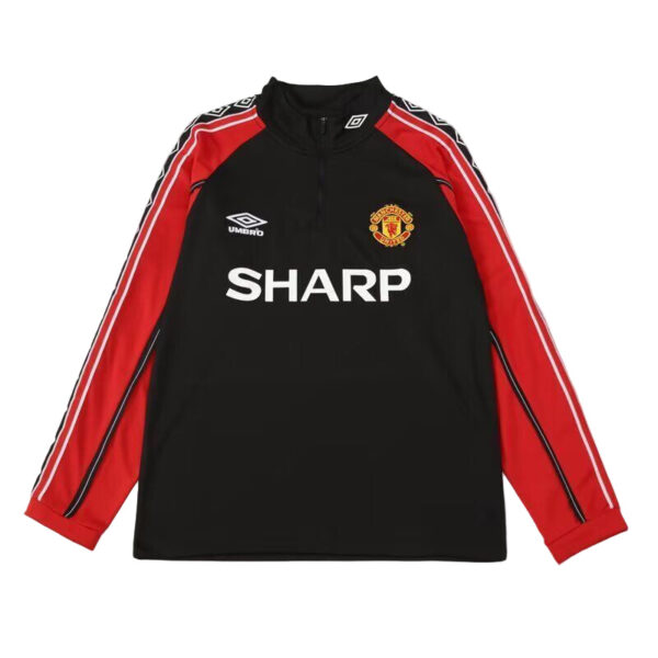Manchester United training jacket: black body, red sleeves with white stripes, team crest on chest and SHARP sponsor text front center.