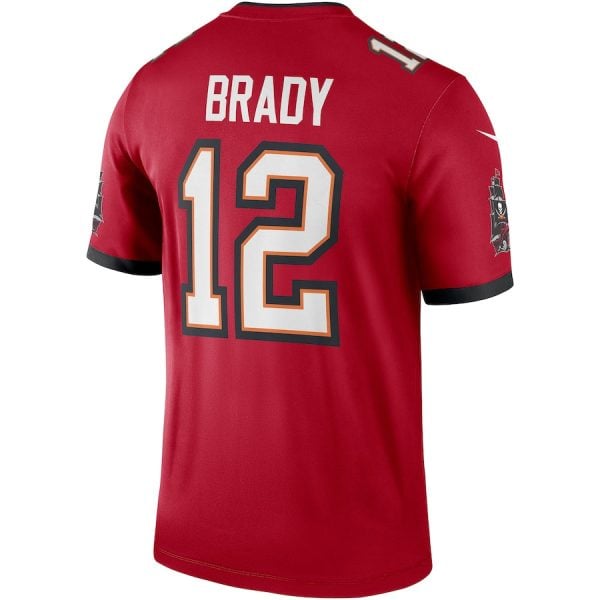 Back view of a red jersey with the name BRADY and the number 12 in white with orange/black outline