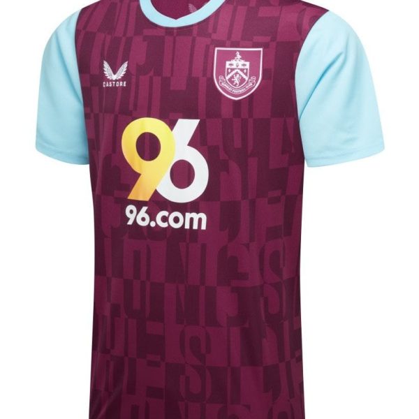 Maroon soccer jersey with light blue sleeves, crest on the chest, and a bold yellow '96.com' sponsor logo across the front.
