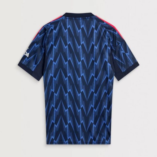 Back view of a blue zigzag-patterned sports jersey with dark sleeves and red shoulder stripes.