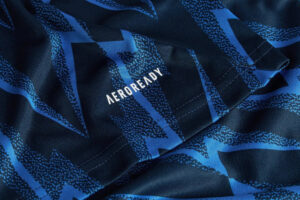 Close-up of blue patterned fabric with the AEROREADY logo visible.