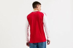 mji9536_b | UAE SPORT STORE Back view of a person wearing a red long-sleeve shirt with white sleeves, standing against a white background.