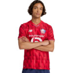 Young man posing in a red LOSC football jersey with arms crossed, facing the camera.