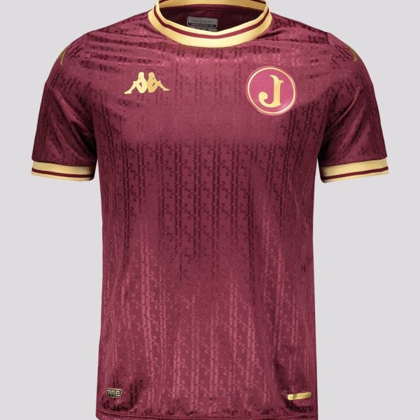 Maroon soccer jersey with gold trim, Kappa logo on the right chest and a circular J crest on the left, featuring an all-over subtle pattern. Best for a product page as a sportswear item.
