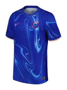 Chelsea FC blue home jersey featuring a swirling light-blue abstract pattern, with Nike swoosh on the right chest and the Chelsea crest on the left chest, orange-trim sleeves.