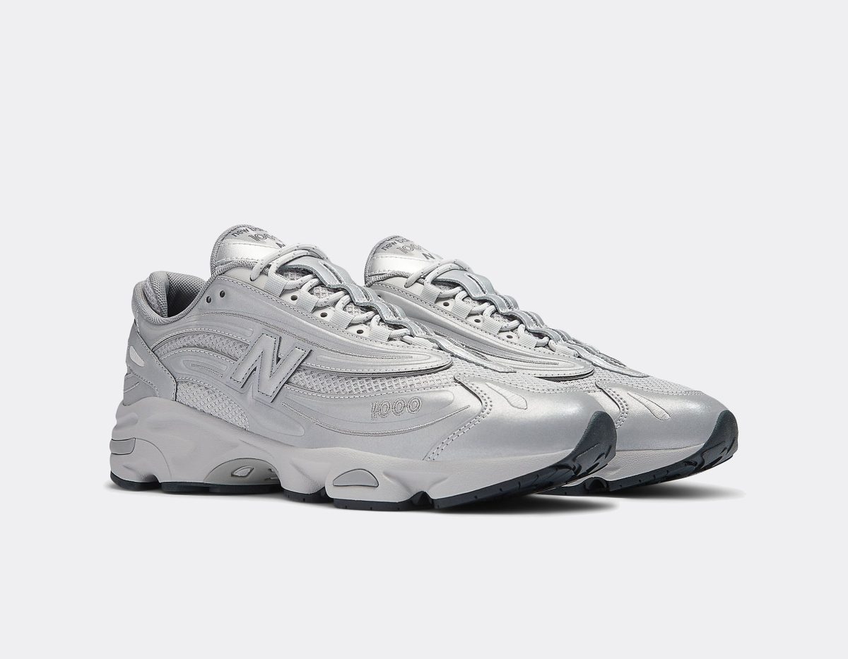 Pair of gray athletic sneakers shown from the side on a light background, with chunky soles and laces tied.