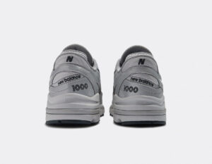 Pair of gray New Balance sneakers viewed from the back showcasing 'new balance' and '1000' on the heel.