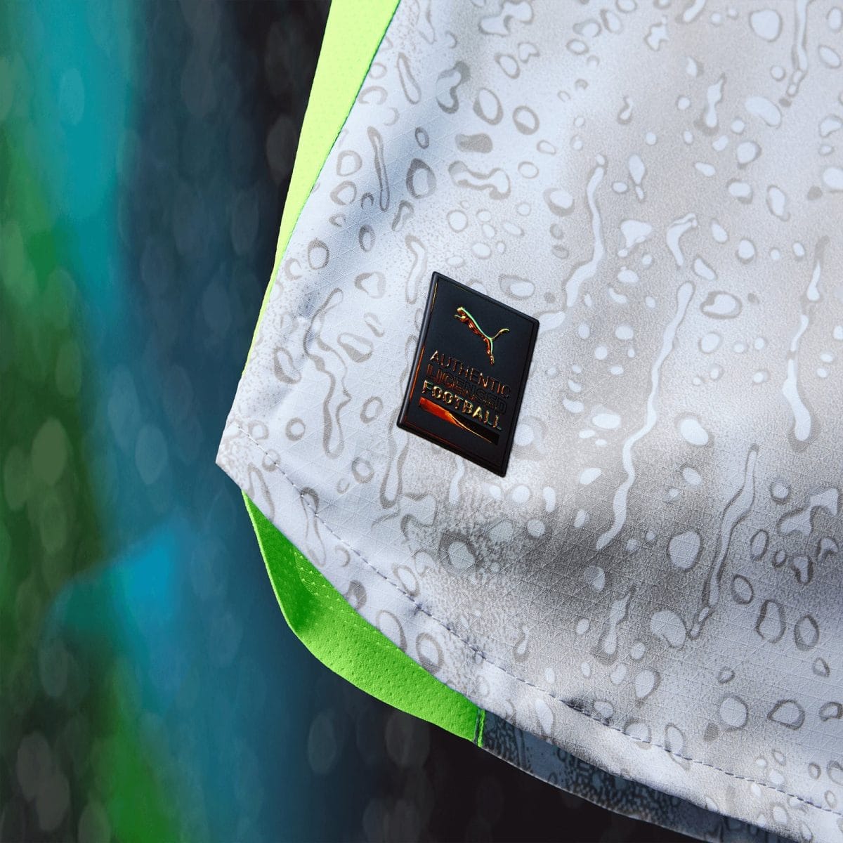 Close-up of a white athletic shoe with a neon green edge and a small badge reading 'Authentic Licensed Product'.
