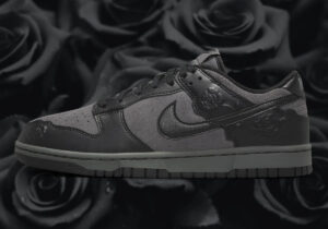 Gray Nike sneaker with embossed floral pattern on heel area against a dark rose background, side view showing swoosh and laces.