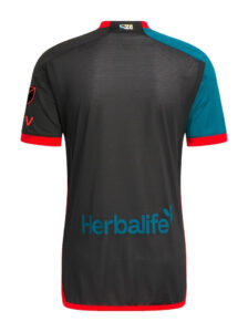 nmYH9a05bGbxb09 | UAE SPORT STORE Back view of a black Herbalife-sponsored athletic jersey with teal right sleeve and red trim at cuffs and hem.