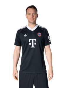 Male model wearing a black FC Bayern jersey with white collar, chest sponsor logo, and Adidas stripes on shoulders, front view.
