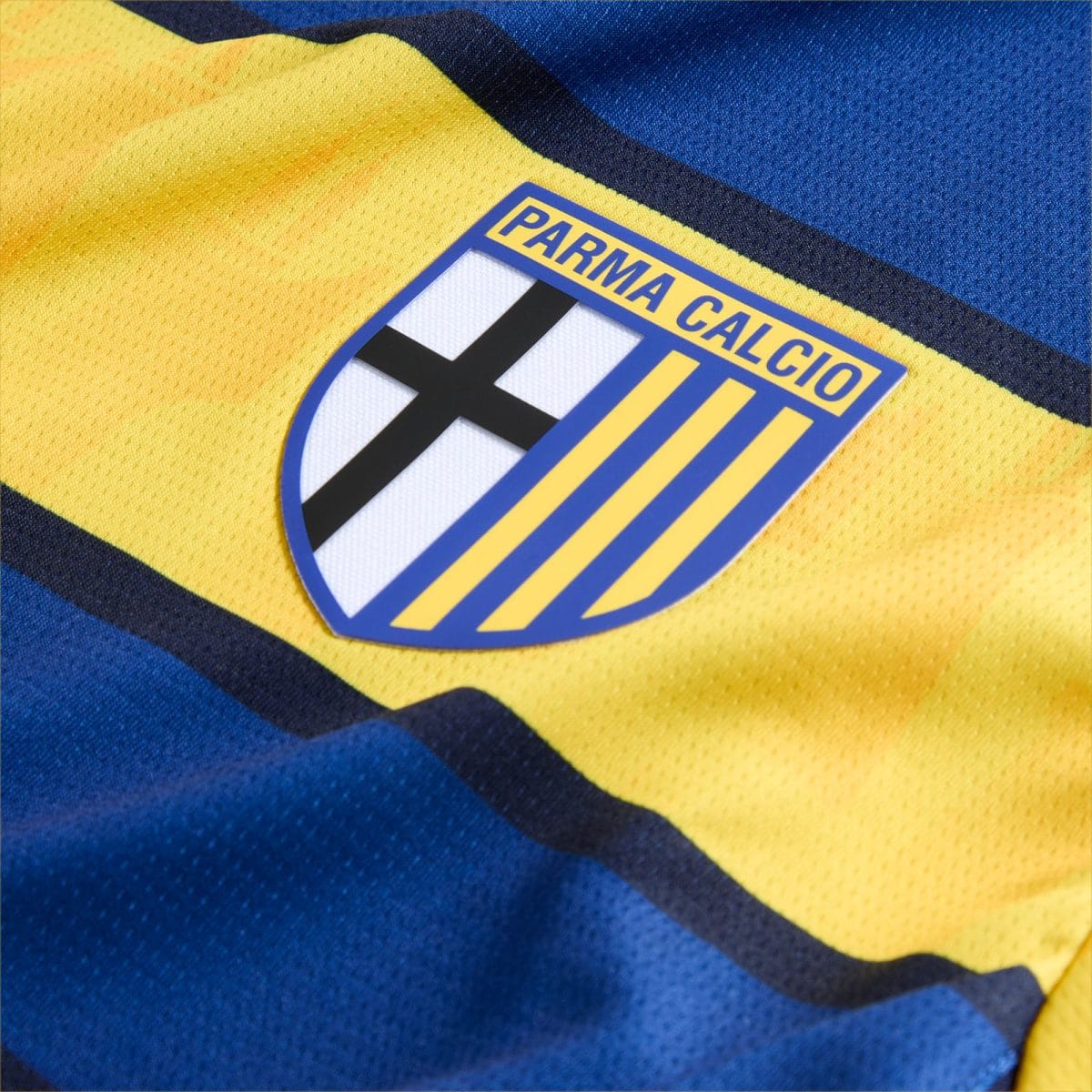 Parma Calcio crest on a bright yellow jersey with blue trim and striped motif in the background.