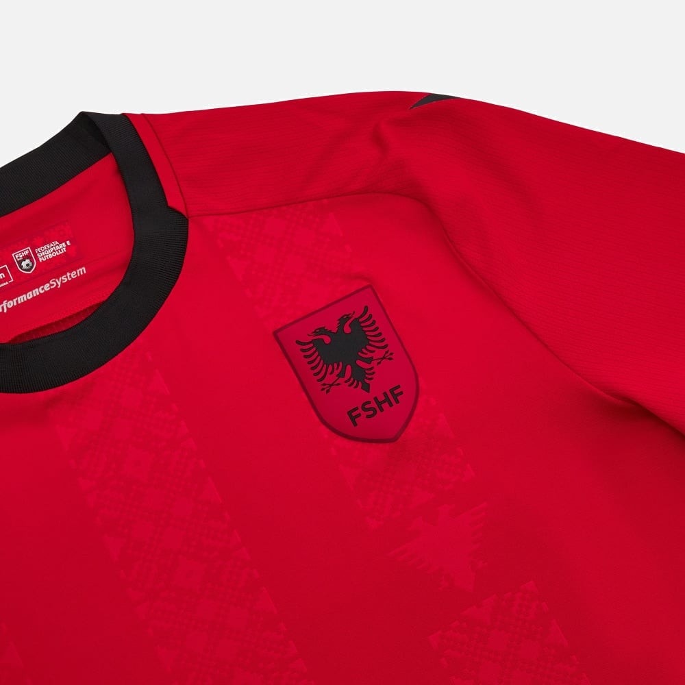oZCuzW3nDQiqXEk | UAE SPORT STORE Close-up of a red sports jersey with a black collar and an FSHF crest featuring an eagle on the chest left side