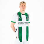 Man wearing a white Borussia Mönchengladbach football jersey with green vertical stripes and REUTER sponsor logo, standing against a white background.