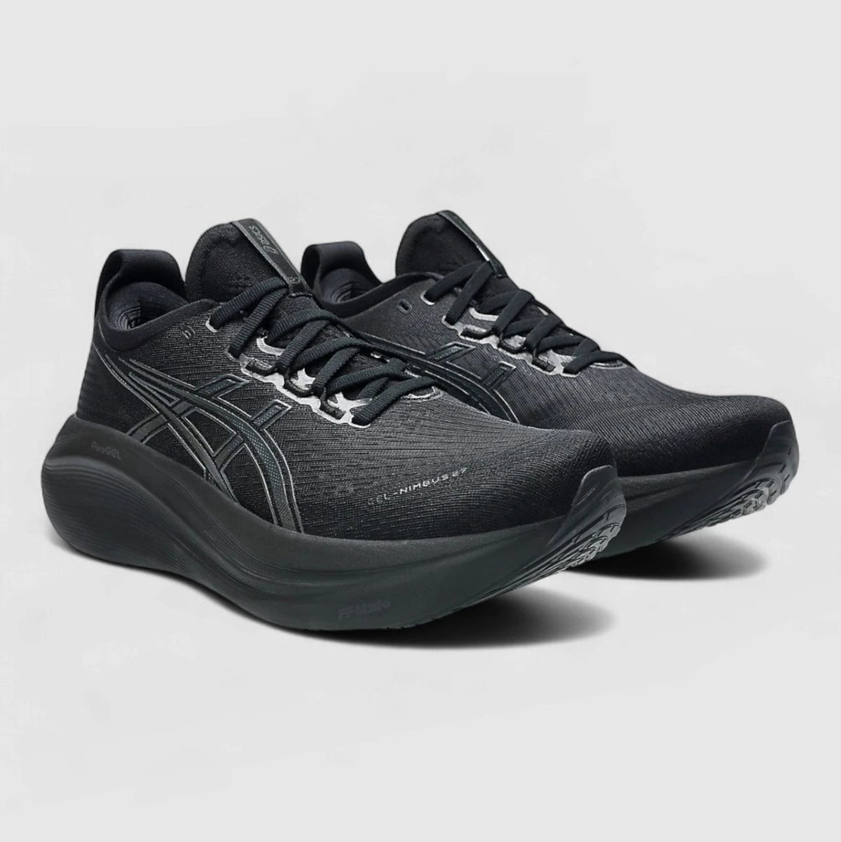Pair of black running shoes with a thick curved sole and gray/white detailing on a light background.