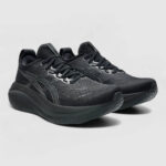 Pair of black running shoes with a thick curved sole and gray/white detailing on a light background.