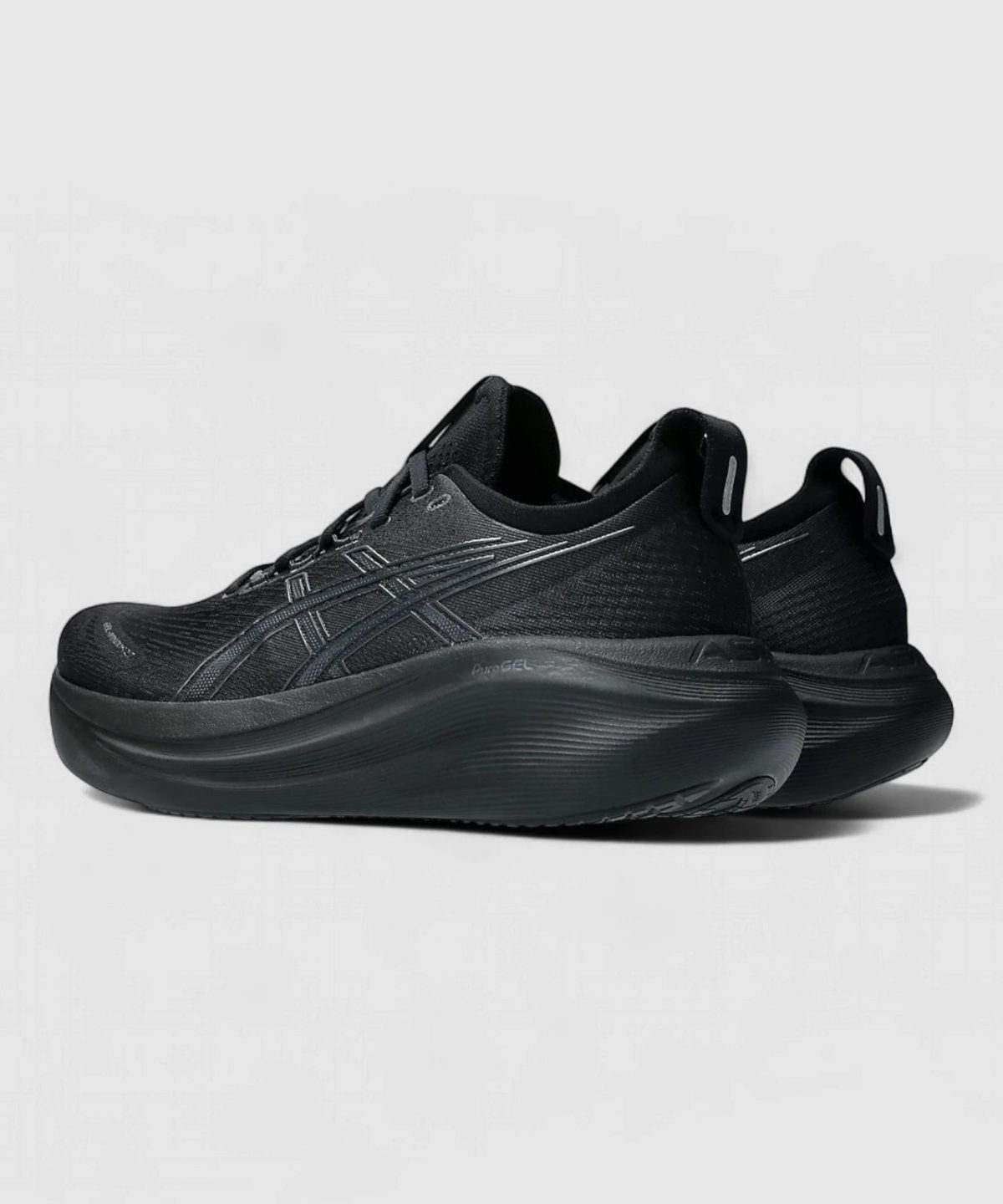Pair of black athletic sneakers with thick, sculpted sole and subtle branding on the side ready for running or training