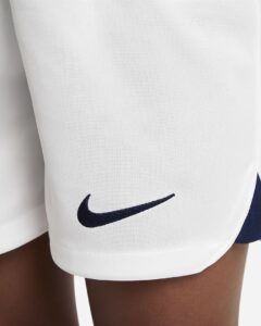 White athletic shorts with a navy Nike swoosh logo on the leg edge.