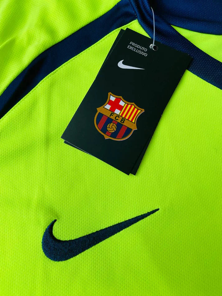 photo_1_2024-02-18_01-47-59_5d4feddb-eb14-4f56-a866-3748baed74f2 | UAE SPORT STORE Bright neon yellow Nike sports jersey with FC Barcelona tag and crest.