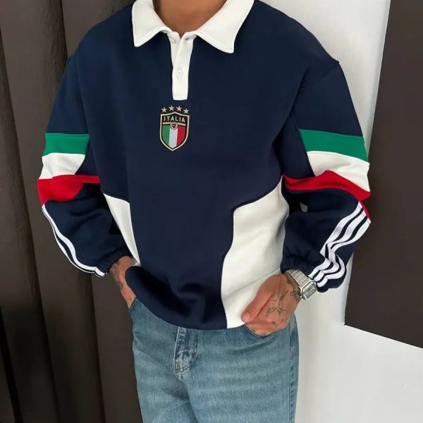 Person wearing a navy rugby shirt with a white collar, Italian crest, and green/white/red striped sleeves, paired with jeans.