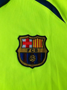 photo_3_2024-02-18_01-47-59_b7630658-de53-46af-be87-7a9eed7c99fe | UAE SPORT STORE Neon yellow sports jersey with an embroidered FC Barcelona crest badge in the center of the image.