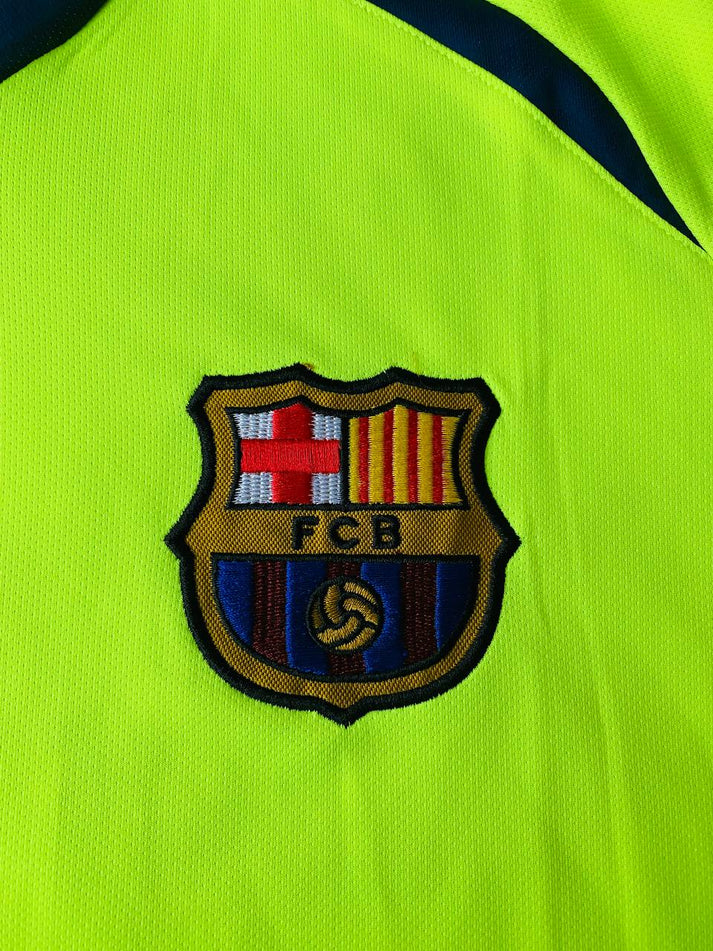 photo_3_2024-02-18_01-47-59_b7630658-de53-46af-be87-7a9eed7c99fe | UAE SPORT STORE Neon yellow sports jersey with an embroidered FC Barcelona crest badge in the center of the image.