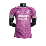 Pink Real Madrid soccer jersey on a mannequin, emblazoned with the Emirates Fly Better sponsor and club crest on the chest.