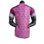 Back view of a purple patterned short-sleeve shirt on a mannequin, with white bands on the sleeves.