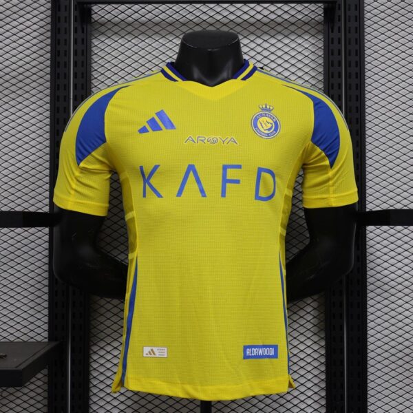 Yellow soccer jersey on a display mannequin with blue trim, Adidas logo, and 'KAFD' sponsor text across the chest.