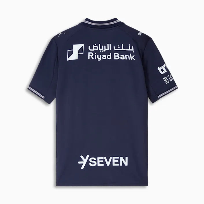 png_1_48877104-edf9-4a02-bd4c-9b3044753035 | UAE SPORT STORE Back of a navy blue sports jersey with Riyad Bank white logo and Arabic text, plus a large SEVEN sponsor at the lower back.