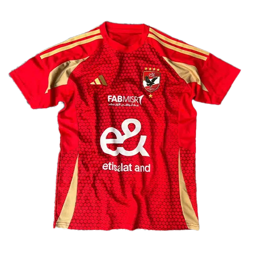 Red football jersey with gold shoulder stripes, club crest, and sponsor logos, featuring a honeycomb pattern on the front for a club kit