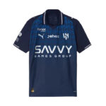 Navy blue soccer jersey featuring the 'Savvy Games Group' sponsor across the chest, with Puma logo and team crest on the front, and patterned blue shoulders.