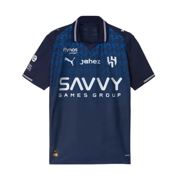 Navy blue soccer jersey featuring the 'Savvy Games Group' sponsor across the chest, with Puma logo and team crest on the front, and patterned blue shoulders.