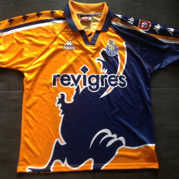 Orange and navy football jersey laid flat with sponsor 'revigres' across the chest and a club crest on the left; Kappa logo near the collar.