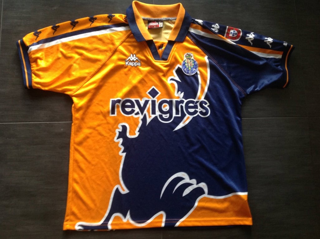 porto-away-football-shirt-1997-1999-s_7174_1_05206a19-2be0-4d0d-8718-781c152125f9 | UAE SPORT STORE Orange and navy football jersey laid flat with sponsor 'revigres' across the chest and a club crest on the left; Kappa logo near the collar.