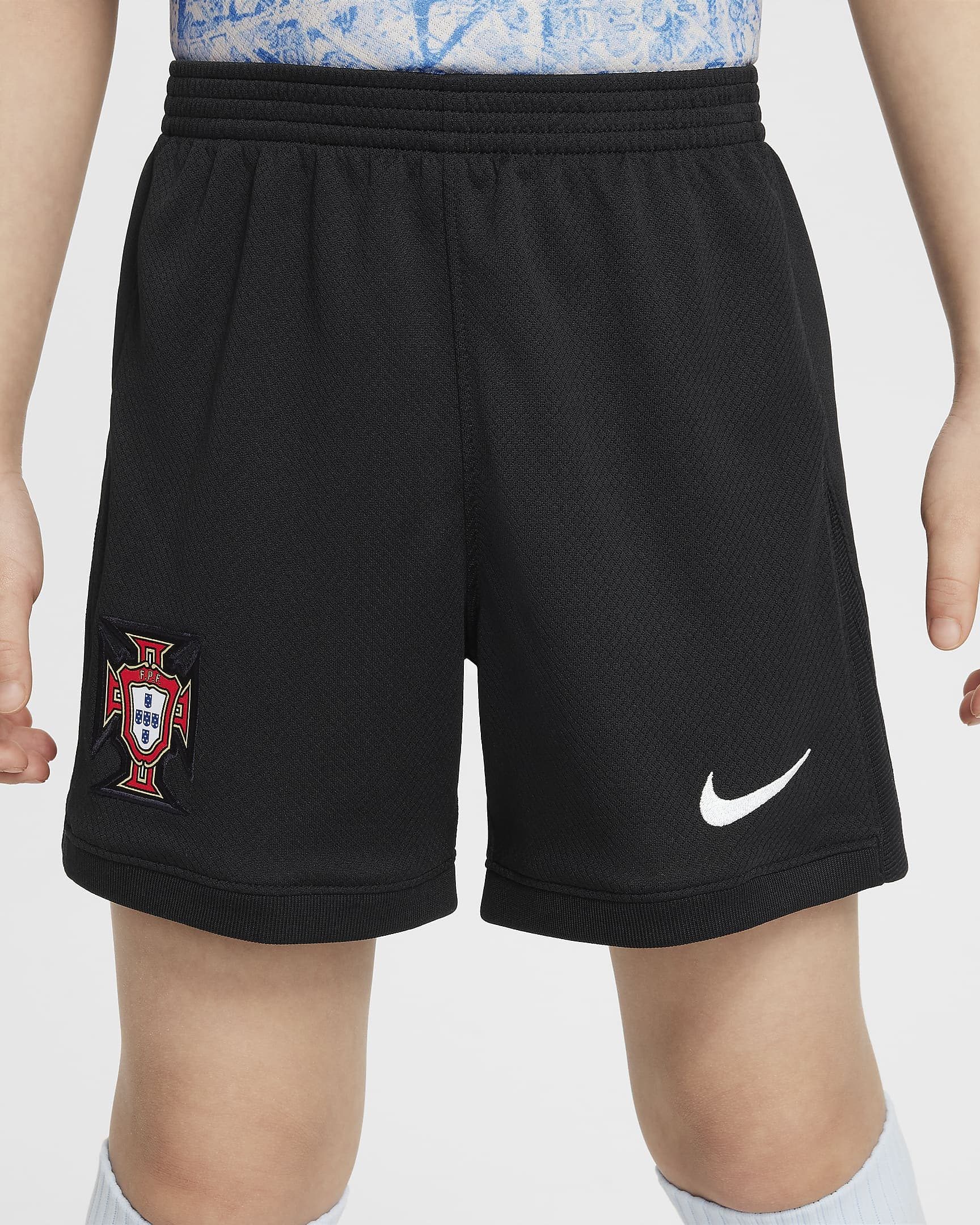 portugal-2024-stadium-away-younger-football-replica-3-piece-kit-4DZQMQ_7 | UAE SPORT STORE Black athletic shorts with Portugal crest on the left leg and a white Nike swoosh on the right leg.