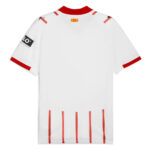 Back view of a white sports jersey with red collar and sleeve cuffs, featuring red vertical stripes along the bottom hem for a bold accent.