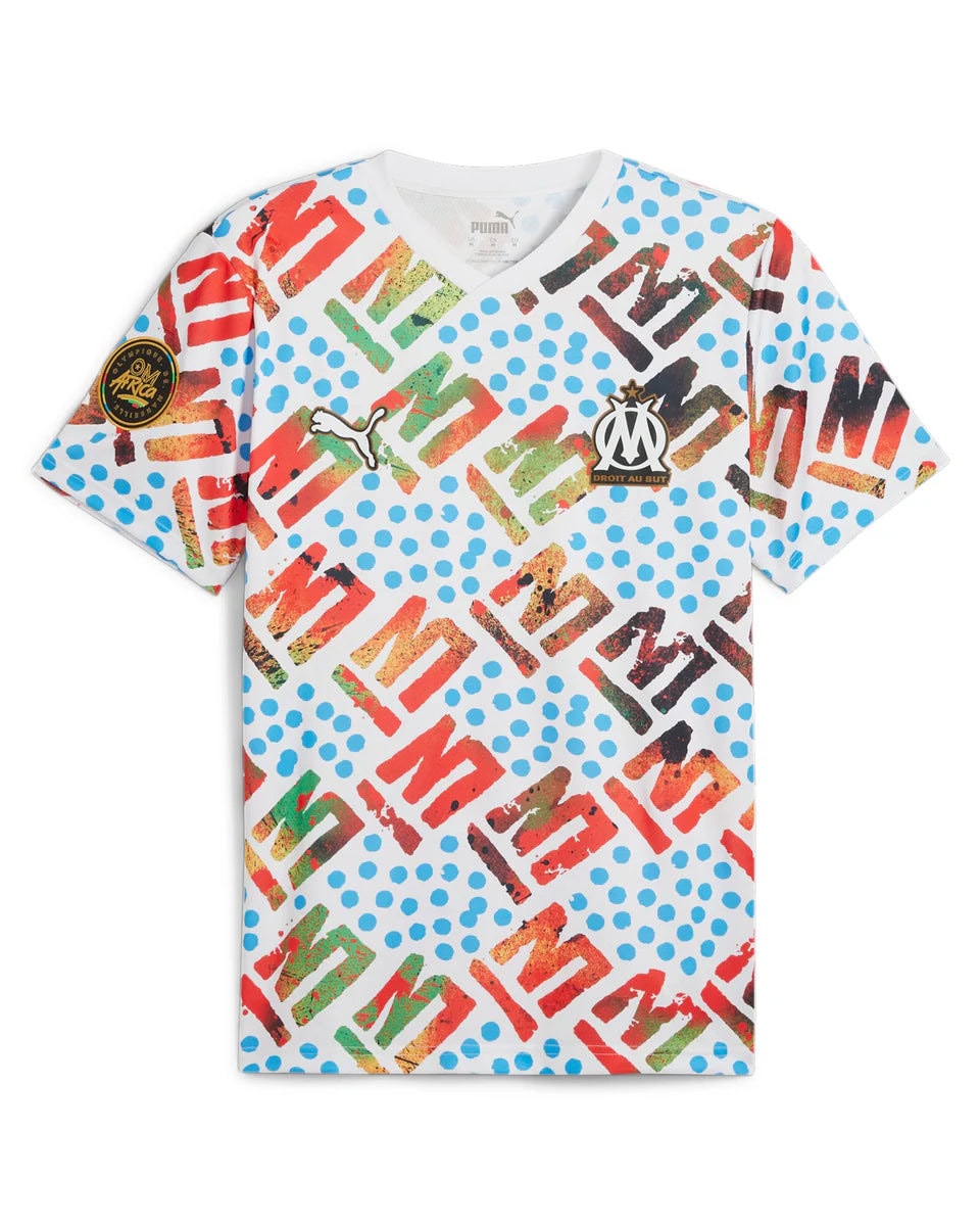 puma__pum-778589-35__imagefront_960x1200_crop_center_ab69b376-e4d1-46ff-ae8f-68d3b18cc545 | UAE SPORT STORE White OM football jersey with multicolored letters, blue polka dots, and Puma logo; club crest on chest.