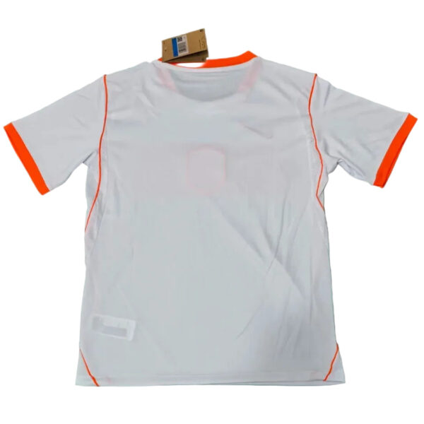 White athletic T-shirt with orange trim on cuffs and seams, tag attached near neckline.
