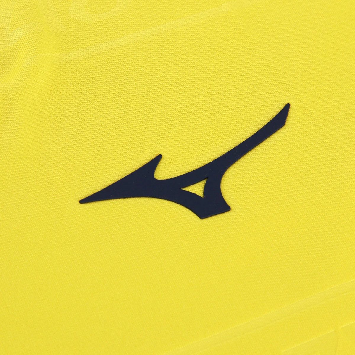 Navy Mizuno Runbird logo on bright yellow athletic fabric (close-up).
