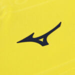 Navy Mizuno Runbird logo on bright yellow athletic fabric (close-up).