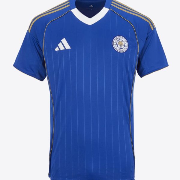 Blue Leicester City football jersey with white V-neck, gold Adidas stripes on shoulders and club crest on the chest.