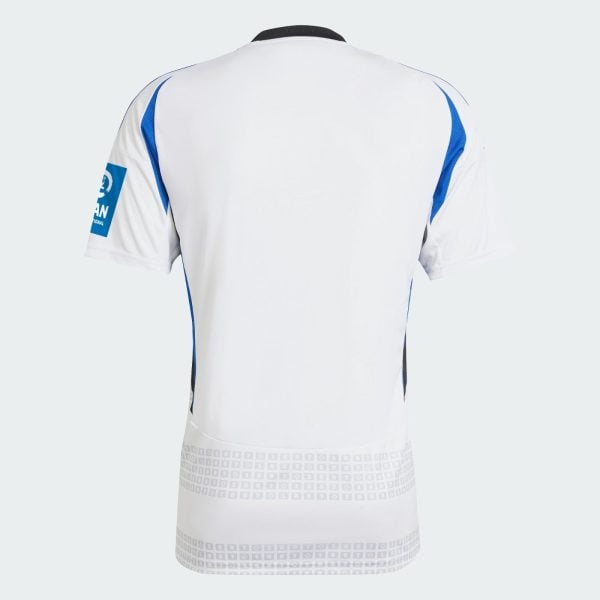 Back view of a white soccer jersey with blue side panels and a black collar. A subtle grid pattern runs along the lower back hem.