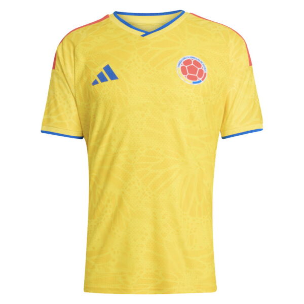 Yellow Colombia national team soccer jersey with blue Adidas logo on the left chest and the Colombian Football Federation crest on the right chest, blue trim at the collar and sleeves.
