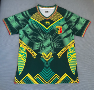 Green football jersey with yellow and teal geometric patterns and a shield crest reading Federation Malienne de Football on the chest, featuring an eagle motif.
